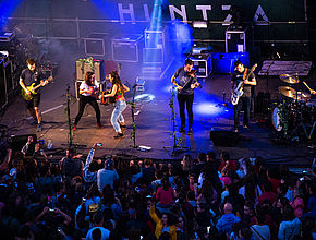 La nuit, un groupe de musiciens joue sur scène devant une foule de spectateurs. - Irudia handitu (modu-leihoa)